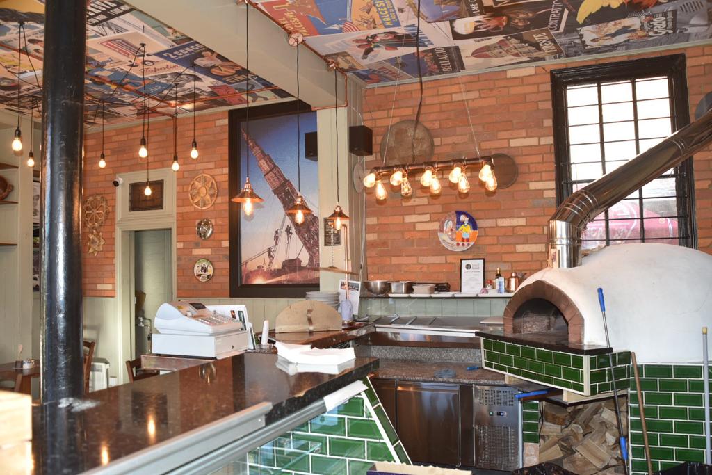 Interior. Ceiling and wall art. Main counter and pizza oven