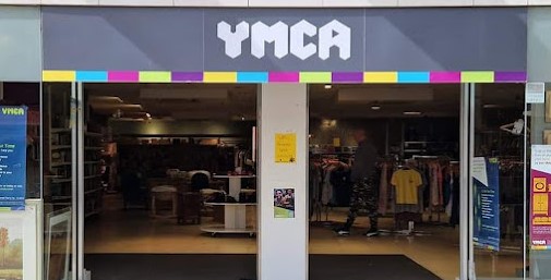 YMCA shopfront with coloured strip underneath white and grey banner