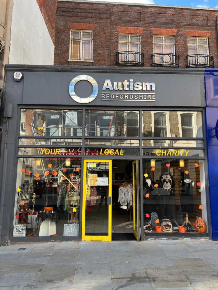 Autism Bedfordshire shopfront with grey and yellow fascia