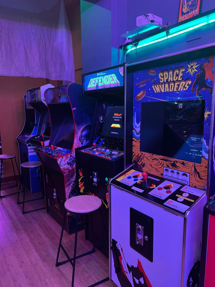 A dark room with arcade machines