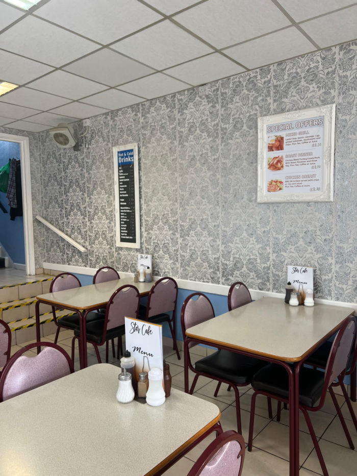 Three interior tables with menu's and condiments