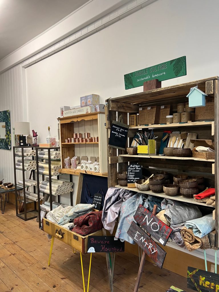 IMPAKT shop showing shelves with soft furnishing and objet d'art