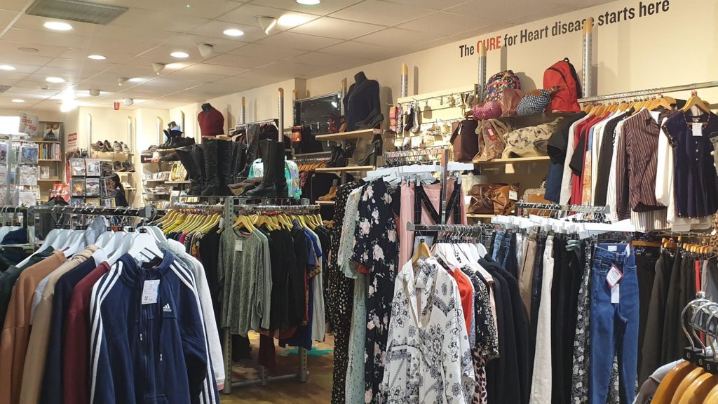 Store interior. A variety of clothes racks featuring both men and womens clothes