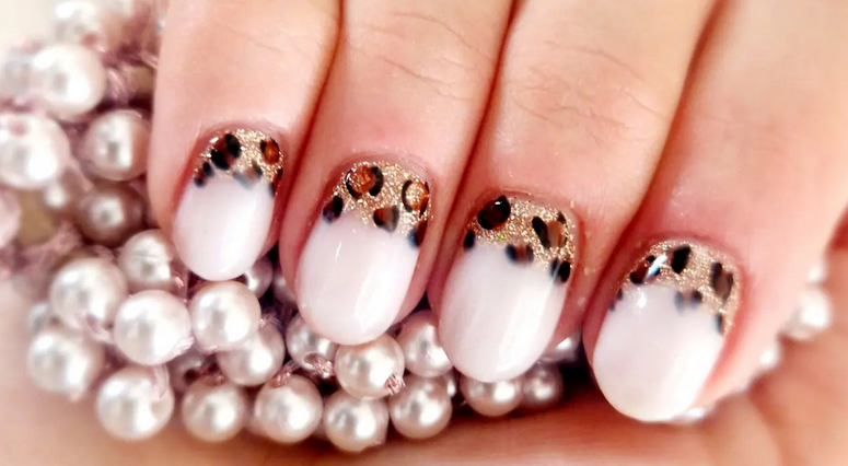 Beauty Cottage leopard print nails with pearls in the background