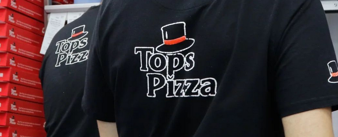 Tops Pizza staff with black red and white branded t-shirts
