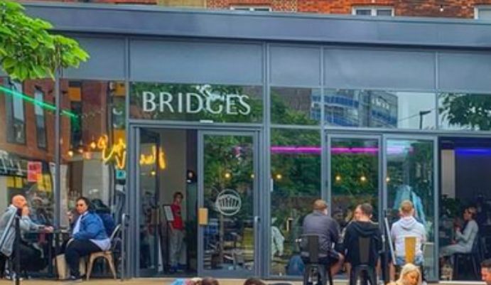 Bridges Cafe shopfront with people sitting outside