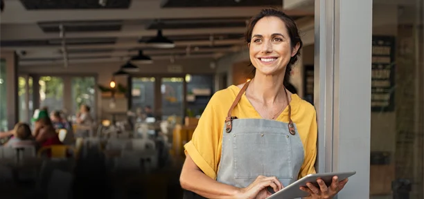 Smiling waitress with tablet serving customers
