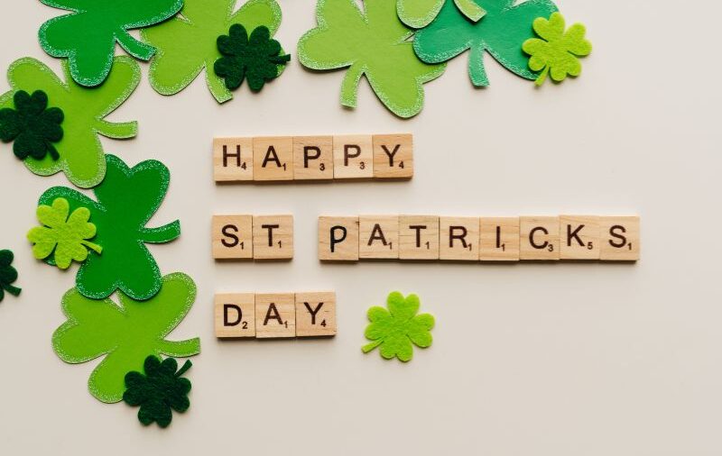 The words Happy St Patrick's Day surrounded by four leaf clovers