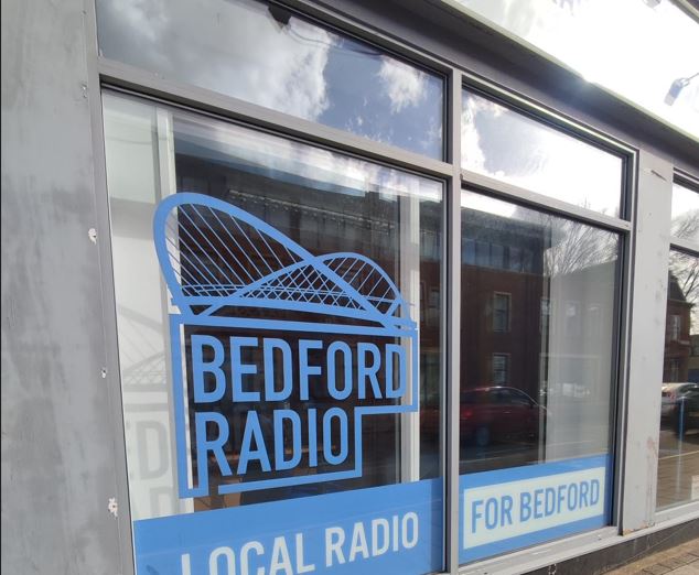 Bedford Radio shop window with blue logo and branding