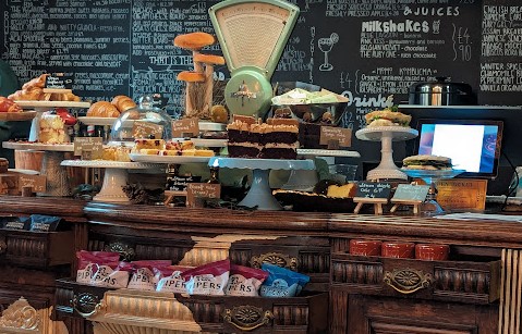 Old Curiosity Cafe counter with cakes and pastries