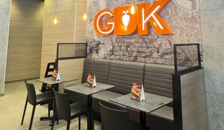 GDK booths with banquettes, chairs, tables and brick wallpaper