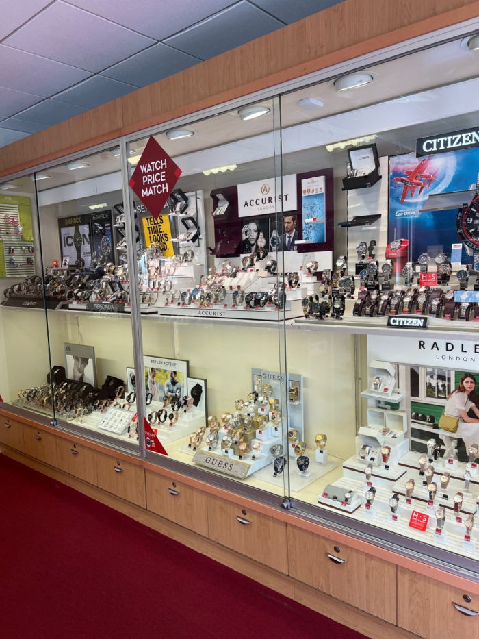 Wall glass cases containing jewellery ,watches and promotional material for brands