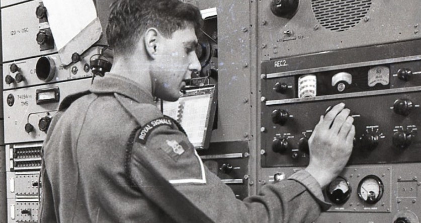 Royal Signals engineer working in the war looking at dials.