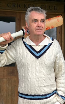 The Quarry Jack's Ashes man in cricket whites with blue trim holding cricket bat