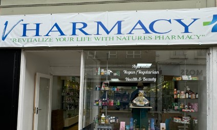 Vharmacy shopfront with logo on banner