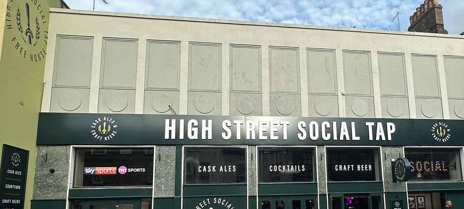 High Street Social street view with large building and cream and forest green logo and paint