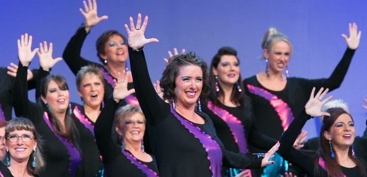 Bedford Sings ladies choir with purple background