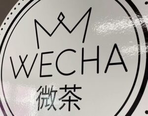 Wecha logo line drawing of crown with word and Asian writing