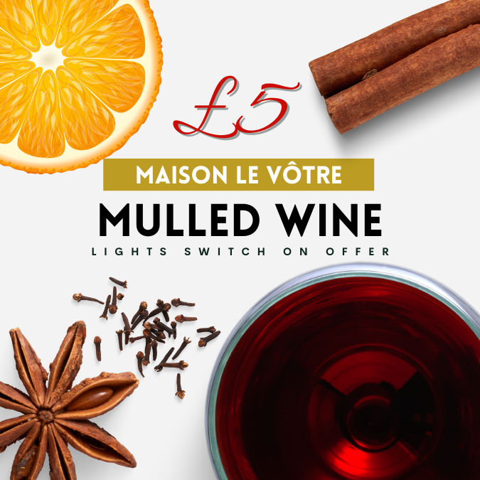 Mulled wine ingredients with a slice of orange, star anise, cloves and cinnamon stick.